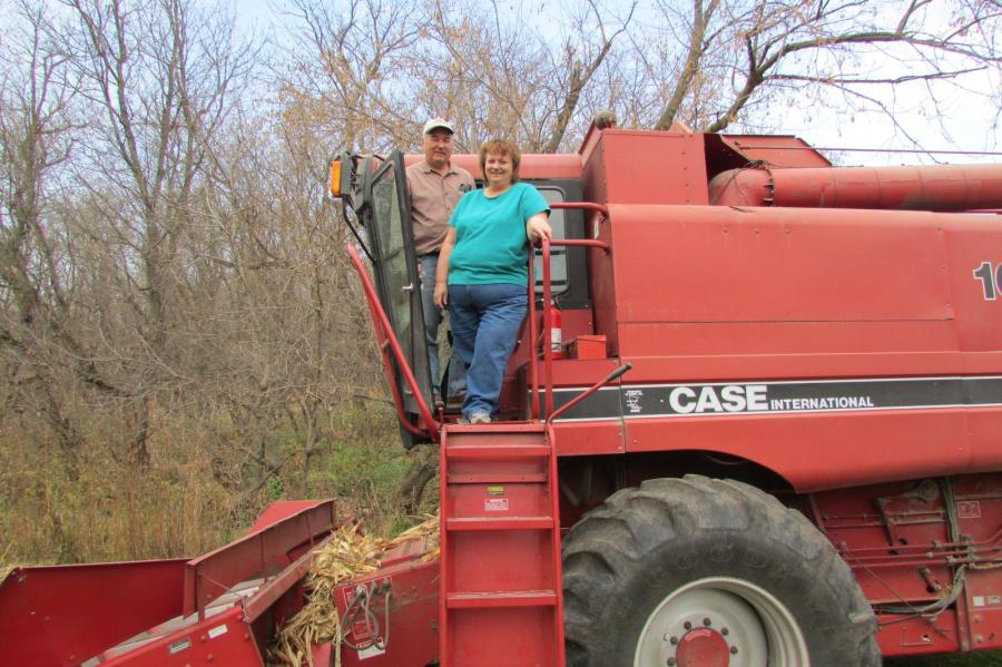 two people on large tractor