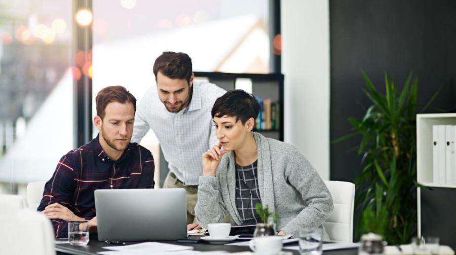 three people looking at a computer screen