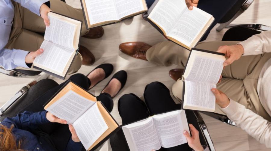 Circle of people holding open books