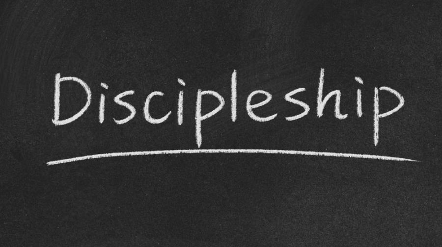 word Discipleship on black background