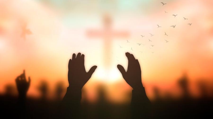 raised hands and cross