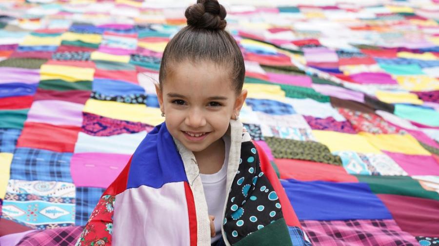 child wrapped in a quilt