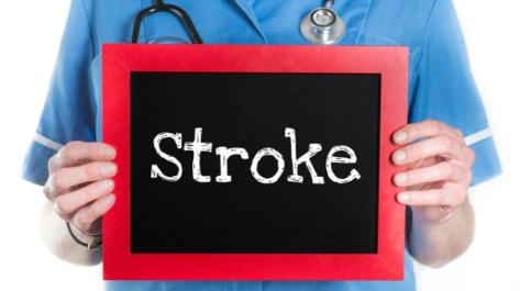 medical person holding sign saying Stroke
