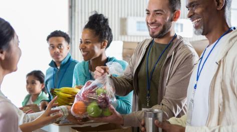 people passing out fresh food